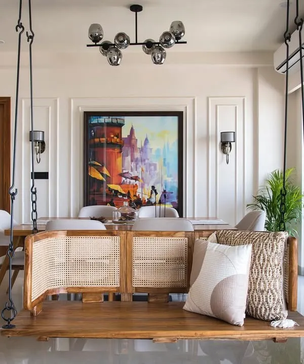 A classic feature in many homes I design is a traditional Indian swing, or 'jhoola'. Here, it’s integrated into a modern living space, offering a playful and relaxing spot with a view of the dining area.