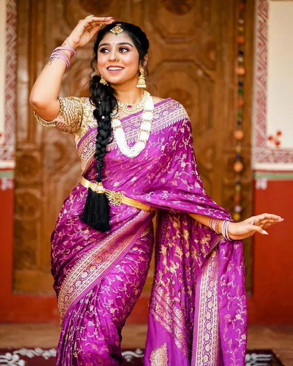 A stunning bridal makeover featuring one of our rich purple Banarasi silk sarees. The all over gold zari work and traditional accessories create a timeless look for any bride.