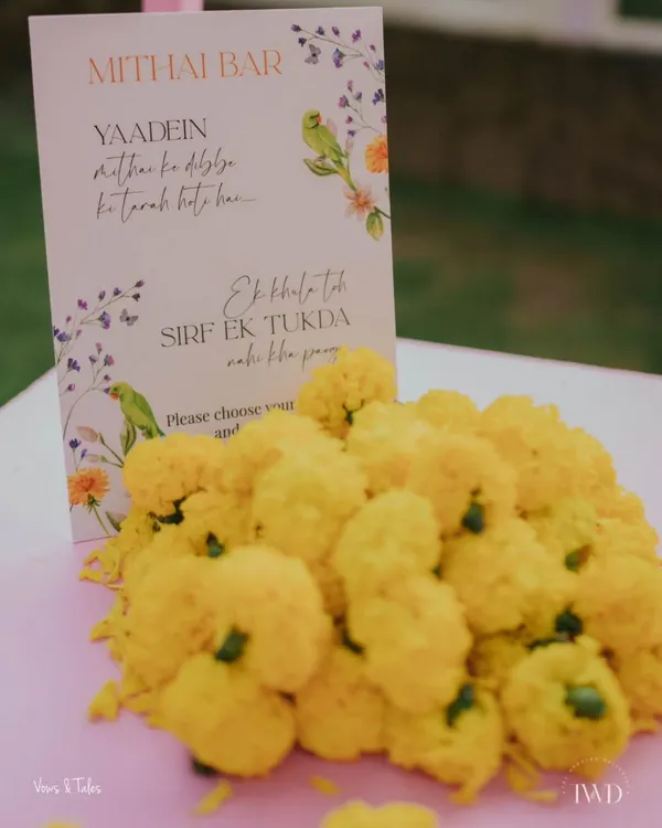 Our custom Mithai Bar, because no one can eat just one. We set up this delightful station with a variety of laddoos, barfis, and dher saara pyaar, complete with a cute sign and traditional marigold decorations.