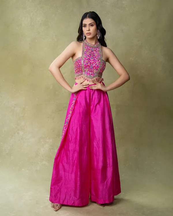 A vibrant e-commerce shot for an ethnic wear brand. The clean background and bright lighting ensure the hot pink color is accurate, while the power pose shows off the full outfit.