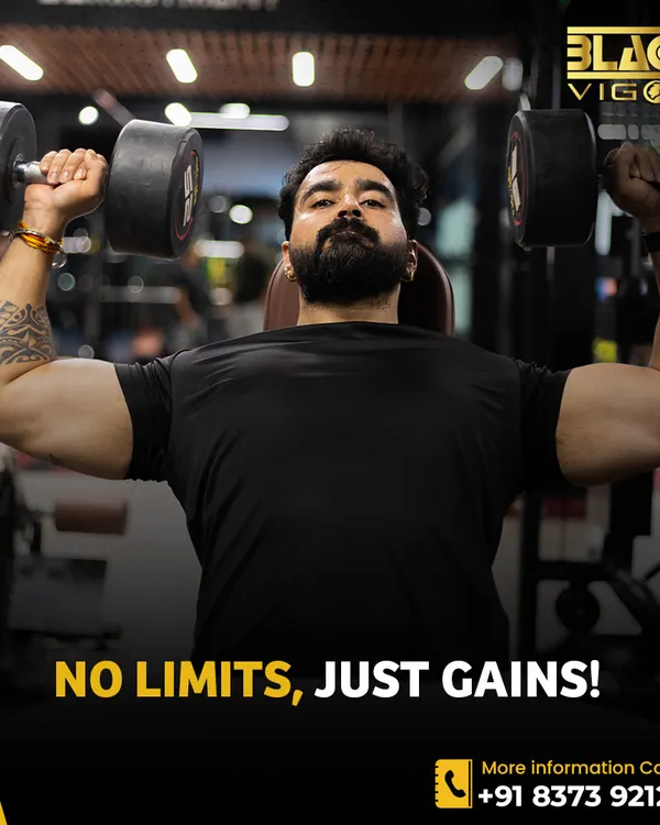 This is our philosophy: No Limits, Just Gains. A member demonstrates a powerful dumbbell shoulder press, embodying the mindset we encourage to push past barriers and achieve new levels of strength.