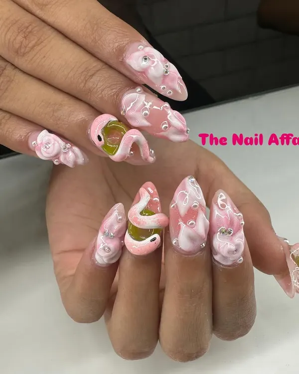 A truly unique and daring design featuring a sculpted 3D snake on a pink base, with water droplet effects and rhinestone accents. This shows the level of custom artistry I can achieve.