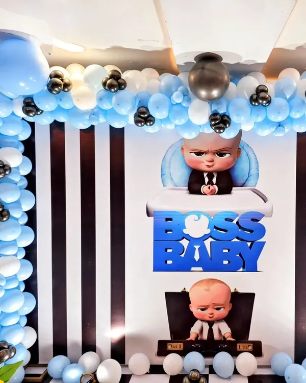 A classic Boss Baby themed birthday party. I used a black and white striped backdrop, a blue and white balloon arch, and character cutouts to bring the popular movie to life.