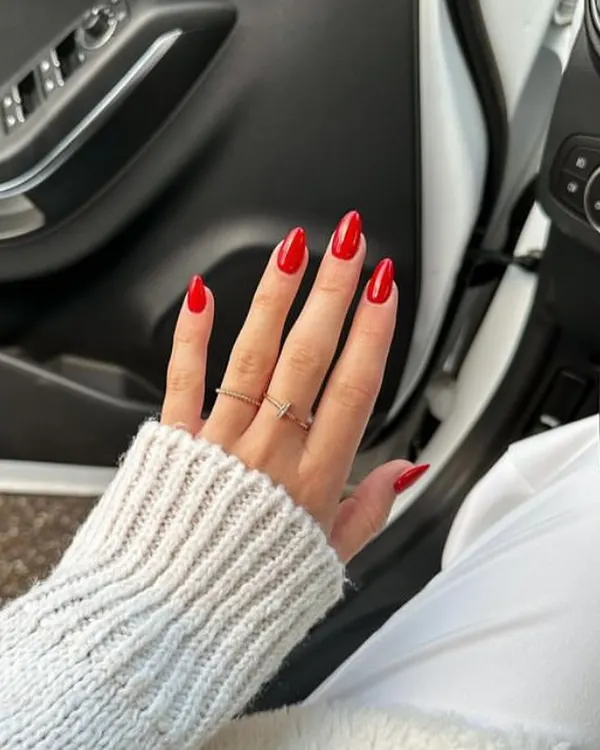 A classic, vibrant red on long almond-shaped nails. A perfect red manicure is timeless, confident, and always in style.