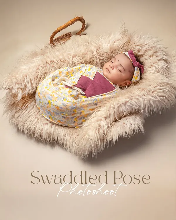 A swaddled pose photoshoot captures the peaceful, sleepy essence of a newborn. Wrapped snugly in a fluffy basket, this baby is the picture of serenity.