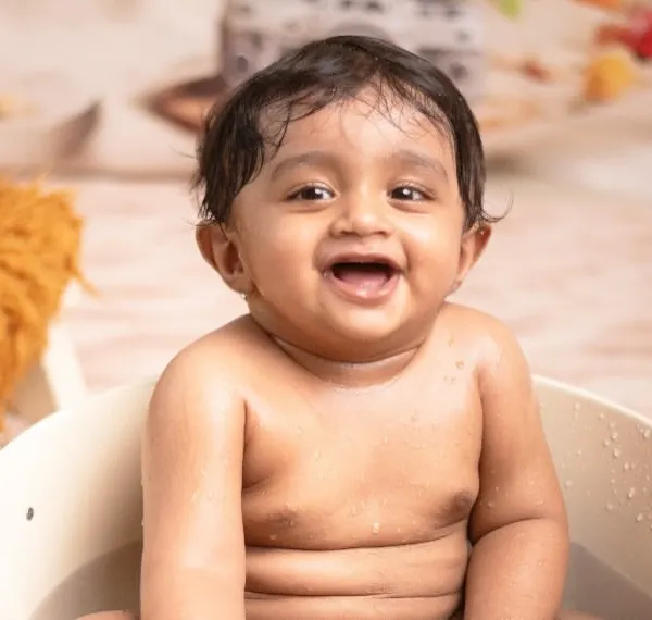 Just look at that happy face! This close-up from a beach-themed tub session captures the pure delight of playing in the water. These are the authentic, joyful moments I love to photograph.