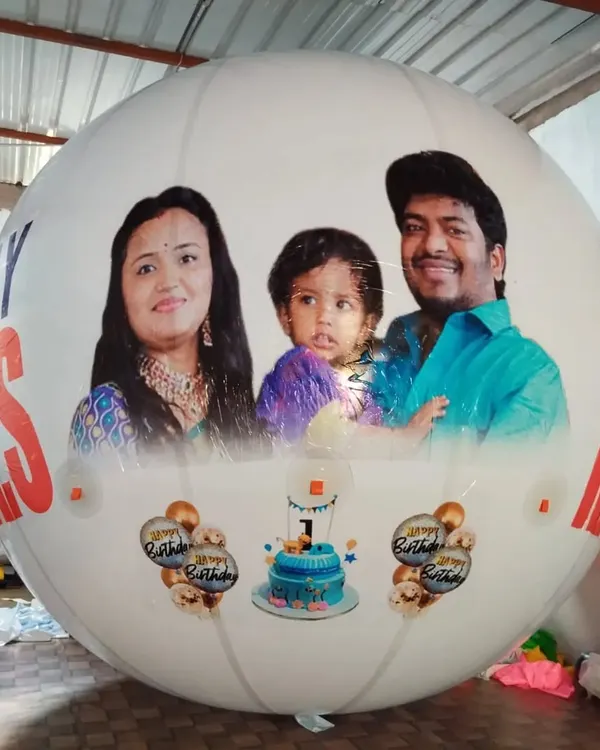 A large, custom-printed advertising balloon featuring a family photograph, suitable for large events or promotions.