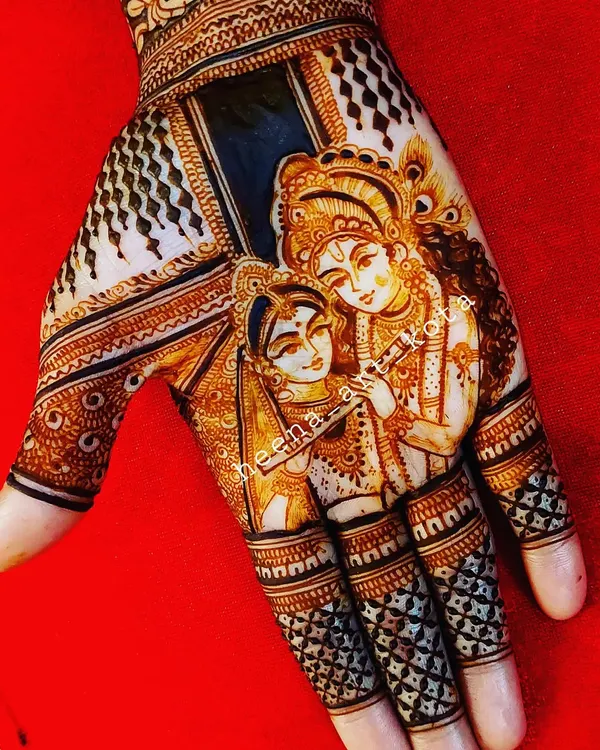 A stunningly detailed portrait of Radha and Krishna on the palm. The use of shading and fine lines brings the divine couple to life, making it a masterpiece of henna art.