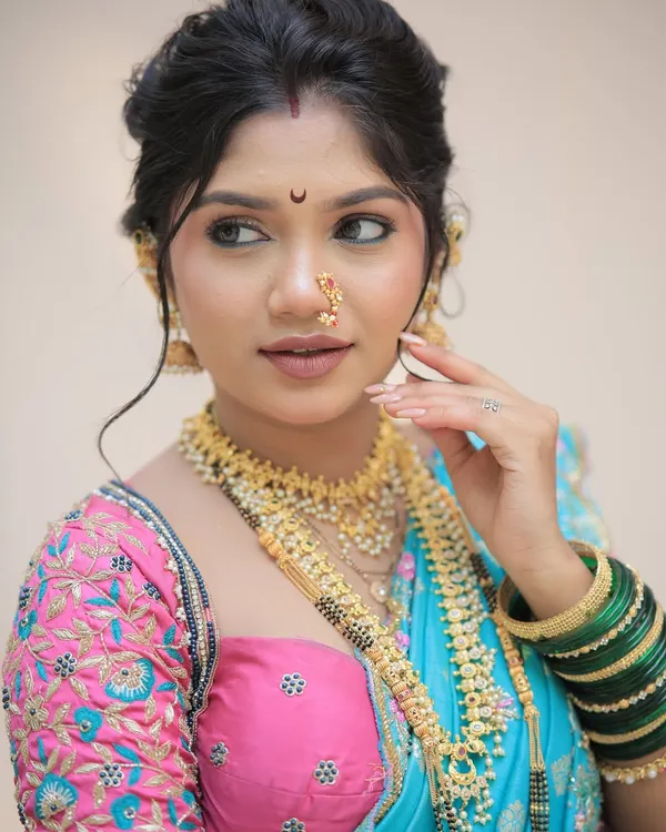 A radiant Gudi Padwa look celebrating Maharashtrian tradition. This client wanted a fresh, festive glow with classic gold jewelry, a crescent bindi, and a natural lip color that perfectly complemented her vibrant saree.