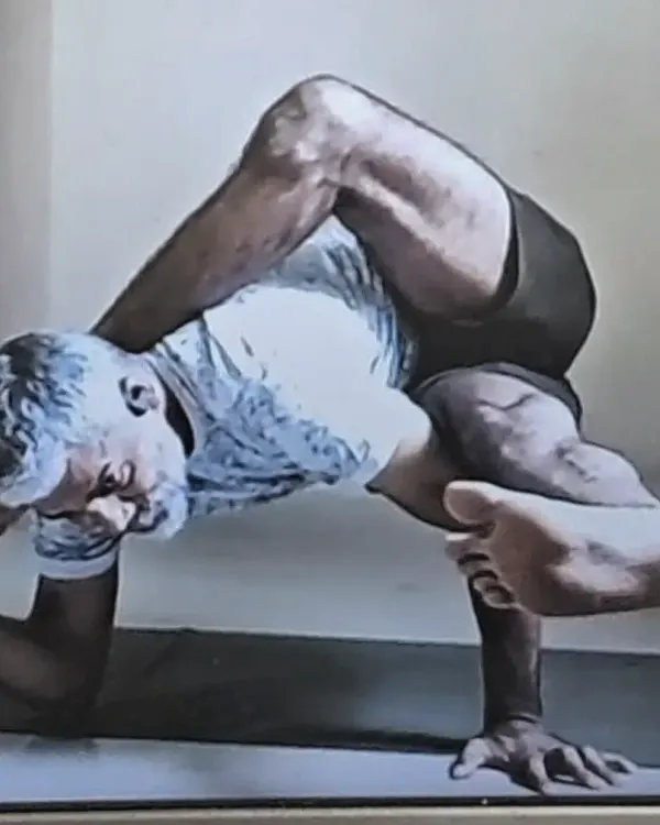 This is Purna Ardha Matsyendrasana, an advanced twisting and arm-balancing pose that demands significant flexibility and strength. My practice is a testament to the dedication I bring to teaching these complex asanas.