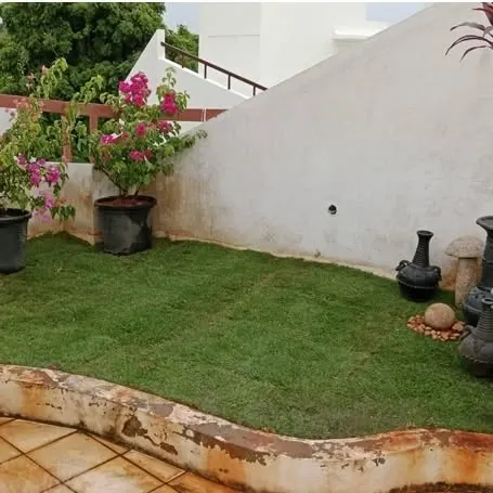 This terrace was transformed with a beautiful artificial grass lawn. It provides a soft, green surface that's perfect for relaxing, and it stays looking this good year-round with almost no effort.