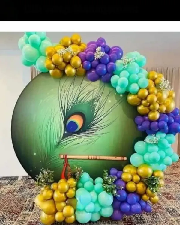 This is one of my favorite custom backdrops, created for a Krishna Janmashtami celebration. I designed and hand-painted the large peacock feather panel and added a traditional flute, framed by a beautiful balloon arrangement in gold, purple, and teal. It creates a divine and artistic centerpiece for any religious event.