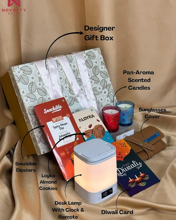 This hamper is the perfect blend of modern convenience and relaxation. It features a desk lamp with a clock and remote, pan-aroma scented candles, a sunglasses cover, and assorted snacks, all packed in a beautiful designer box.