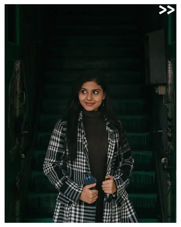 A moody portrait taken on a dark staircase. I love using shadows and ambient light to create a sense of atmosphere and focus on the subject's expression.