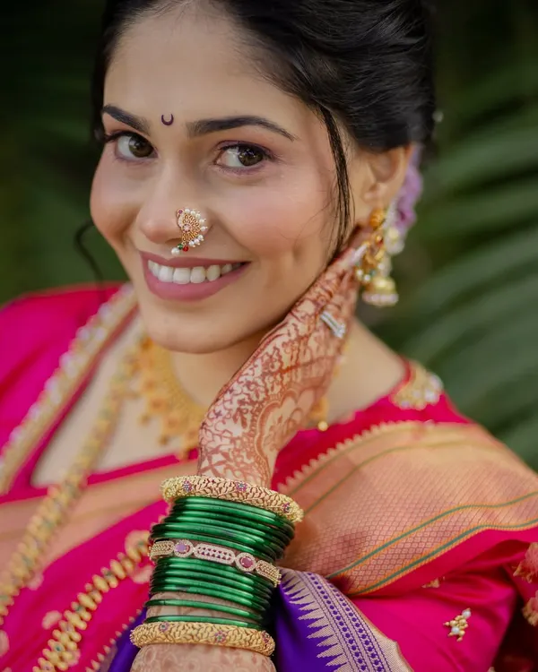 This is the joy I strive for with every bride. This beautiful close-up captures the essence of a traditional Maharashtrian look, with soft, glowing makeup, a classic chandrakor bindi, and an elegant nath that completes the picture.