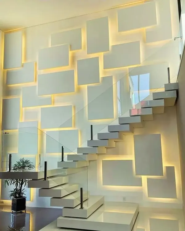 This is how I turn a simple staircase area into a stunning focal point. I designed and installed these custom floating gypsum panels with integrated warm backlighting to create a modern, high-end feature wall that transforms the entire space.