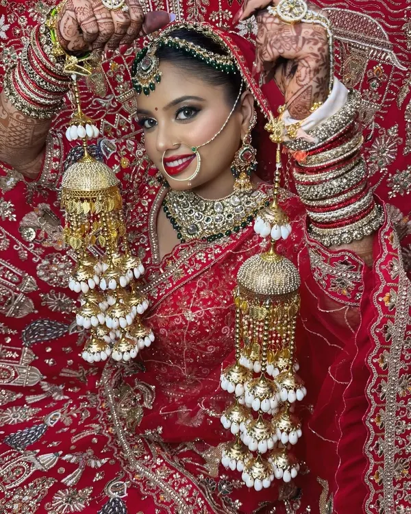 This is the look I love creating: timeless, radiant, and classically bridal. I focused on creating flawless skin, a bold red lip that complements the traditional lehenga, and defined eyes that shine, making her feel like the most beautiful version of herself.