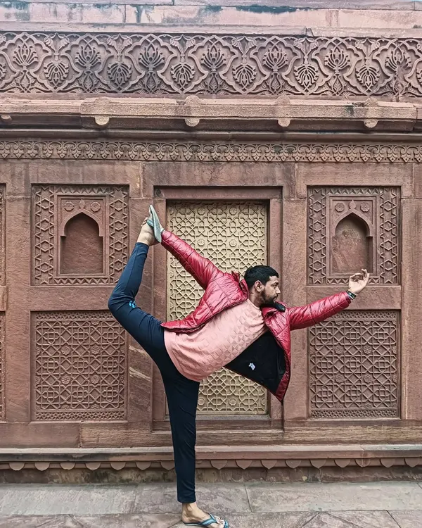 Striking a dancer pose at Agra Fort, even though they said yoga was not allowed. Sometimes you have to bend the rules.