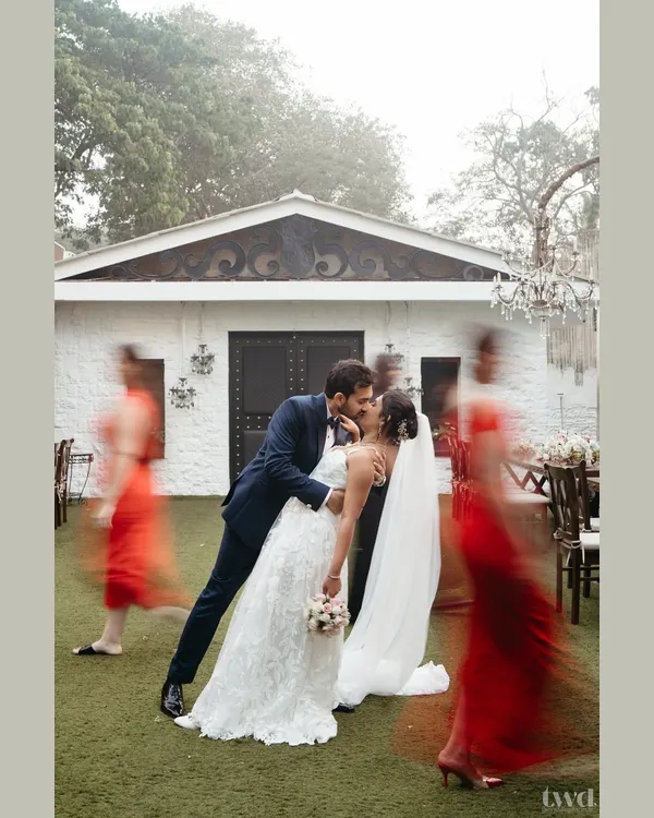 A creative motion-blur shot capturing the couple's kiss just after their first look. While the world rushes by in a blur of color, they are frozen in a perfect, still moment of love and anticipation before their wedding ceremony.