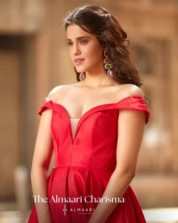 This off-the-shoulder red gown is pure glamour. The structured bodice and deep neckline are designed to make a powerful statement, perfect for any black-tie event or formal party.