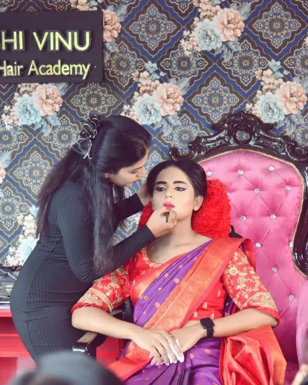 Here I am doing a live makeup demonstration for my students. I explain every step of the process, from skin preparation to the final lipstick application, so they understand the 'why' behind every technique.