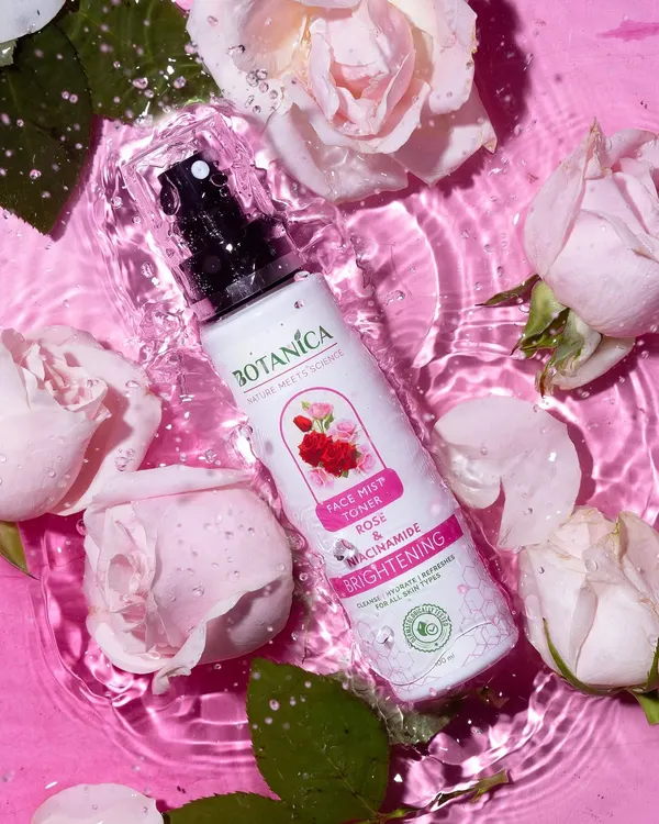 A refreshing shot of a rose face mist surrounded by real roses in rippling pink water. The frozen water droplets on the bottle add a sense of immediate hydration.