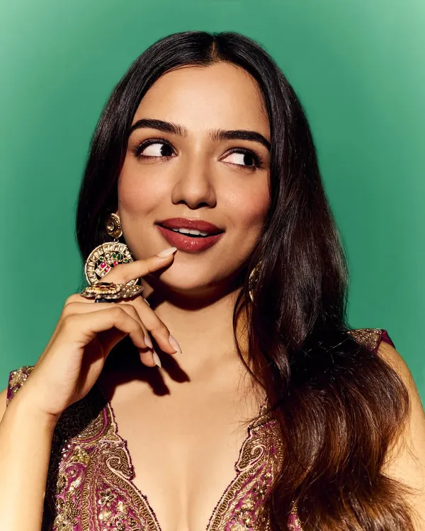 A playful and vibrant look for Ahsaas Channa. This purple and gold ensemble is paired with oversized traditional earrings, showcasing a fun approach to festive dressing.