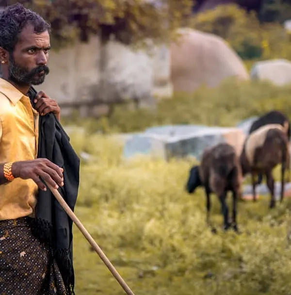 I spotted this shepherd while exploring the countryside around Hampi. His weathered look and the way he held his staff told a story of a life connected to the land. This is the kind of candid portrait I love to capture.