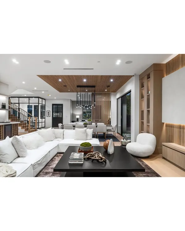 A glimpse into a spacious and bright open-concept home we designed, seamlessly blending the living and dining areas. The design emphasizes natural light, clean lines, and a sophisticated neutral palette to create an atmosphere of modern luxury.