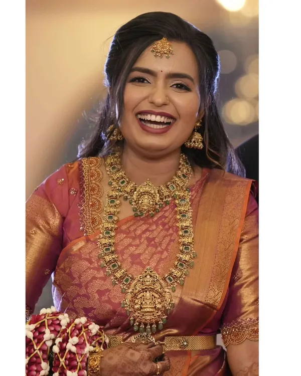 That joyful smile says everything. It is my greatest reward to see a bride looking this happy and confident after I have styled her for the muhurtham. This look features a traditional antique gold finish temple jewellery set with a stunning haram and matching choker.