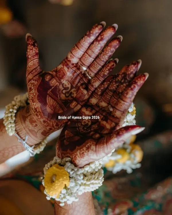 The beauty of a developed stain. This photo shows the deep, rich color of the mehendi on the bride's palms, complemented by her beautiful floral jewelry during the haldi ceremony.