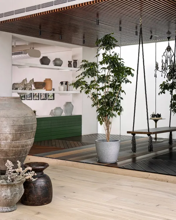 We created distinct zones to showcase different product segments. A raised platform with wooden rafters and a hanging swing creates an inviting, outdoor-inspired nook, separating the space while adding a touch of charm and encouraging exploration.