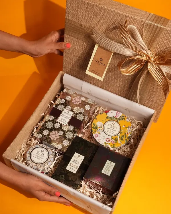 An unboxing moment, revealing a curated selection of our finest home fragrances. This gift set, with its beautiful jute-textured box and gold ribbon, is perfect for housewarmings, birthdays, or simply to show you care.