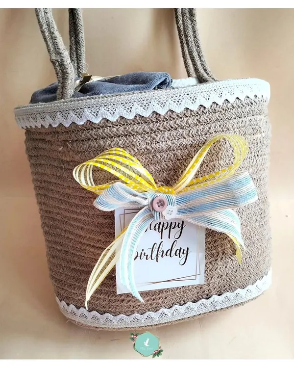 A birthday hamper for a six-year-old, beautifully packed in a reusable jute basket with a colorful ribbon. The presentation is just as important as the surprises inside.
