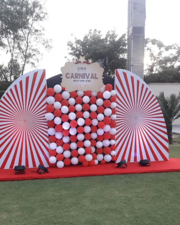 A classic red and white carnival-themed photo booth I set up for an outdoor event. The bold stripes and balloon wall create a festive backdrop for guests to capture memories.