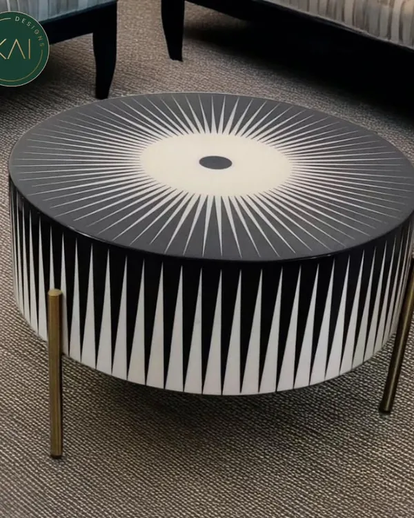 A bold, round coffee table featuring a striking black and white sunburst pattern created with bone inlay. This unique piece is a testament to our dedication to artisanal craftsmanship and creating furniture that makes a statement.
