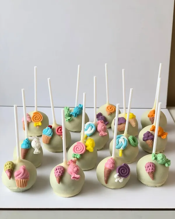 Welcome to Candyland! These fun cake pops are decorated with tiny, handcrafted candies, lollipops, and ice cream cones.