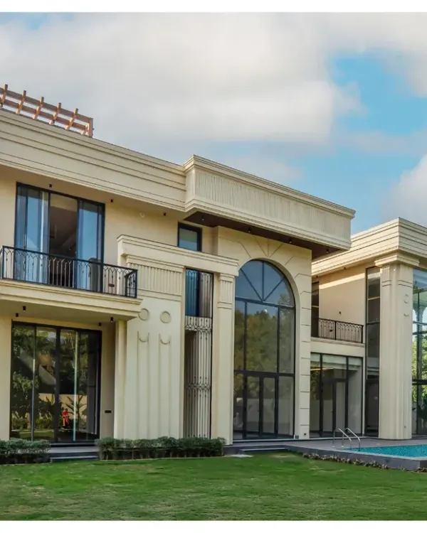 The facade of our Sultanpur farmhouse is a blend of classical charm and modern sophistication. I used grand arches and decorative columns to create a sense of symmetry and timeless appeal, while the double-height glass floods the interiors with natural light.