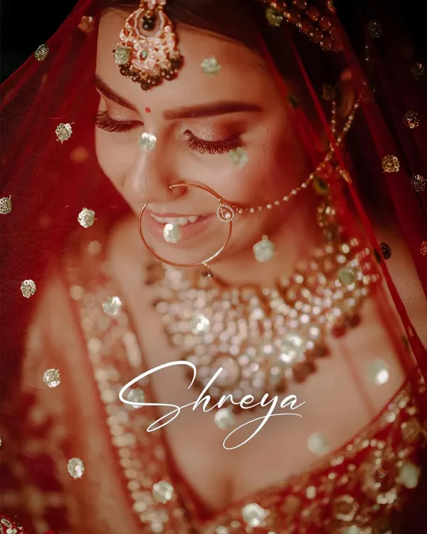 A beautiful close-up of the bride, with a soft, dreamy effect. This portrait captures her happy smile and the intricate details of her nath and jewelry, making it a timeless keepsake.
