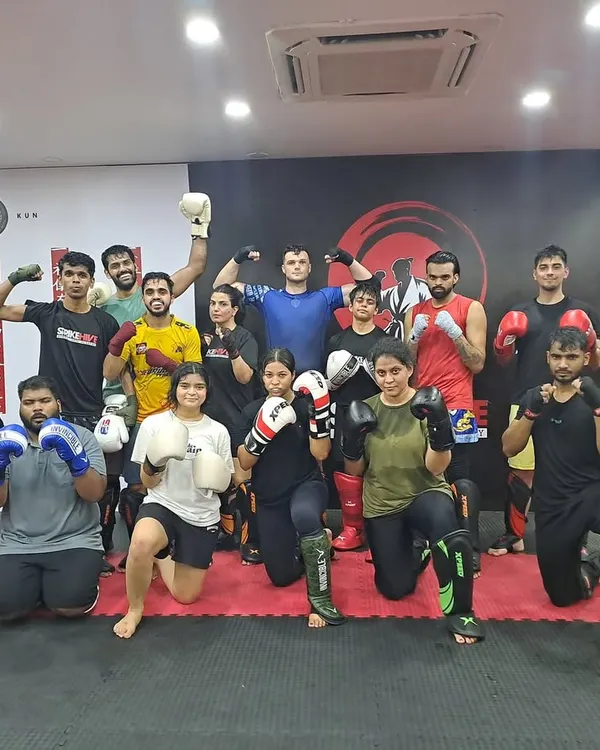 This isn't just a gym. This is family. A large group of our members posing together, showcasing the diverse and inclusive community we have built.