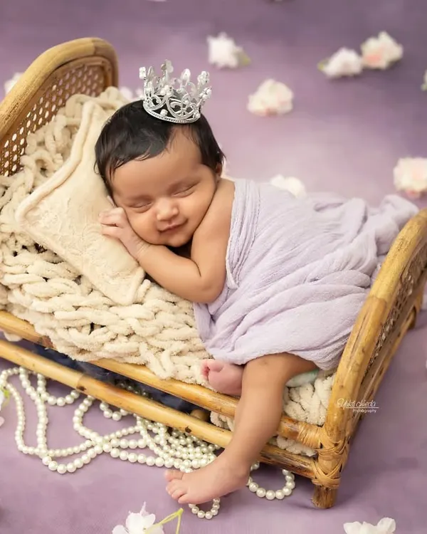 A sleepy smile from a tiny princess. Posing newborns on these miniature beds with soft fabrics creates such a dreamy and classic portrait.
