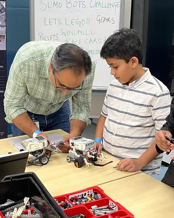 A father and son work together on a Sumo Bot challenge. We love seeing families get involved, with parents acting as mentors and coaches, fueling their child's curiosity and passion for technology.