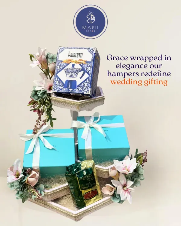 Grace wrapped in elegance. This multi-tiered hamper, adorned with soft florals, redefines wedding gifting by creating a stunning display for your precious presents.
