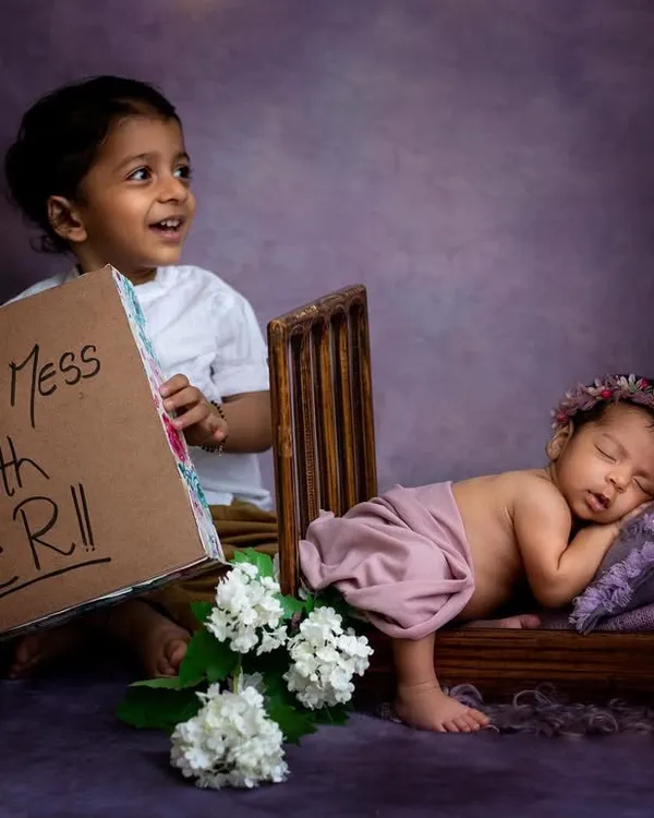 This big brother is already so protective! We had so much fun with this "Don't Mess With Her" sign. Including older siblings in a fun and playful way makes for such memorable photos.