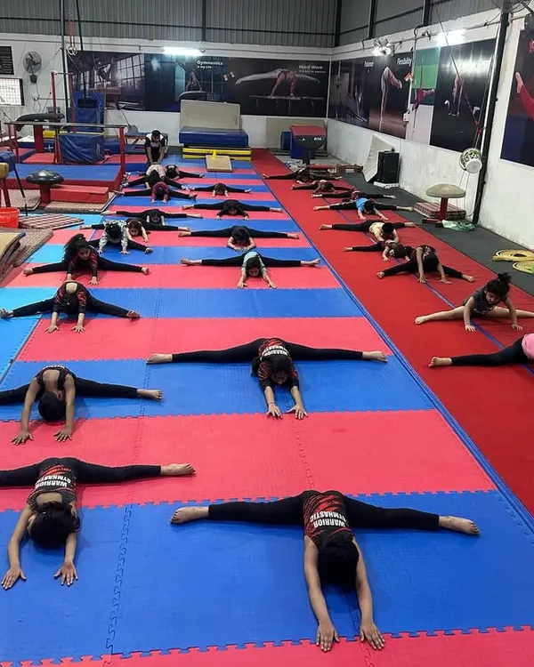 This is where champions are made, on the mats, building flexibility one stretch at a time. Here my students are working on their middle splits, a fundamental requirement for all artistic gymnastics events.