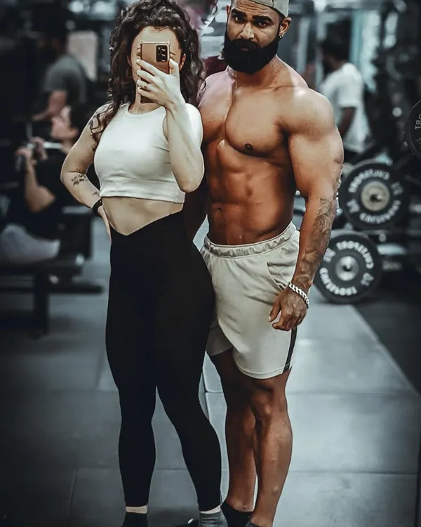 With my partner, who is also my training partner. We support each other's goals both in and out of the gym.