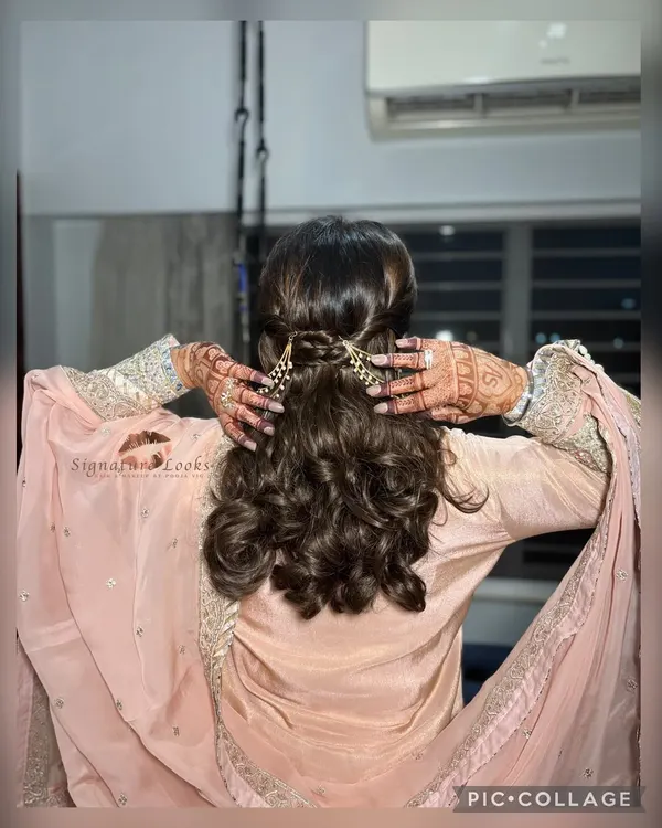 This back view shows the beautiful detail of the half-up style for a Roka ceremony. The hair is twisted neatly and secured with an elegant pearl hair accessory.