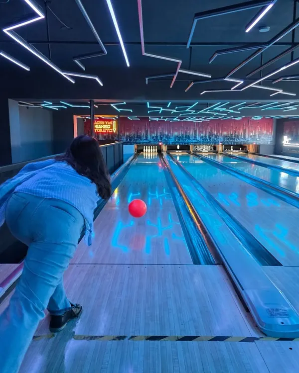 Welcome to The Grid, where the neon lights guide you to the perfect strike. This is where the fun begins, with every roll and every cheer under our futuristic ceiling.