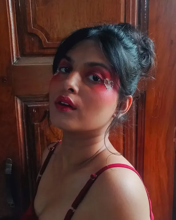 This makeup look is all about bold, romantic expression. I used a heavy red blush and created a heart shape with tiny rhinestones for a dramatic, love-themed look.