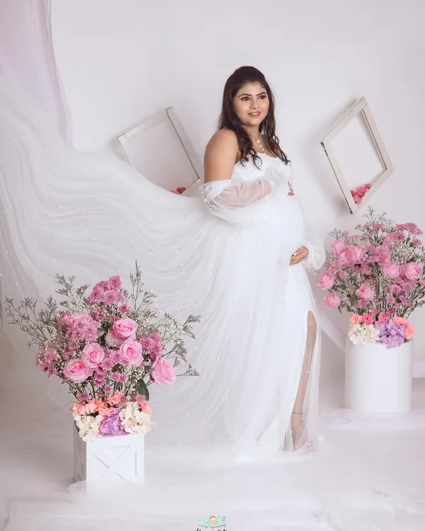 An angelic portrait in our all-white floral setup. We love creating a sense of movement by letting the sheer fabric of the gown float, adding to the dreamy feel.